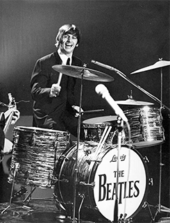 Ringo Starr playing drums with the Beatles onstage (1965). Original source: Biography, www.biography.com/musicians/ringo-starr.